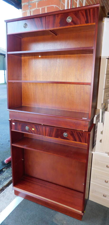 A pair of reproduction mahogany bookcases, each having two drawers, 104cm high, 92cm wide, 30cm