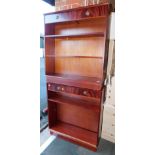 A pair of reproduction mahogany bookcases, each having two drawers, 104cm high, 92cm wide, 30cm