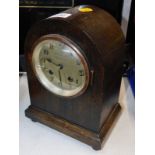 An early 20thC oak cased mantel clock for Barron Clark & Company Peterborough, silvered circular