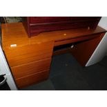 A teak effect dressing table, with three left hand drawers, 73cm high, 111cm wide, 40cm deep.