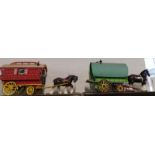 Two painted and carved wooden Romany caravans, with pottery cart horses, 63cm and 69cm wide
