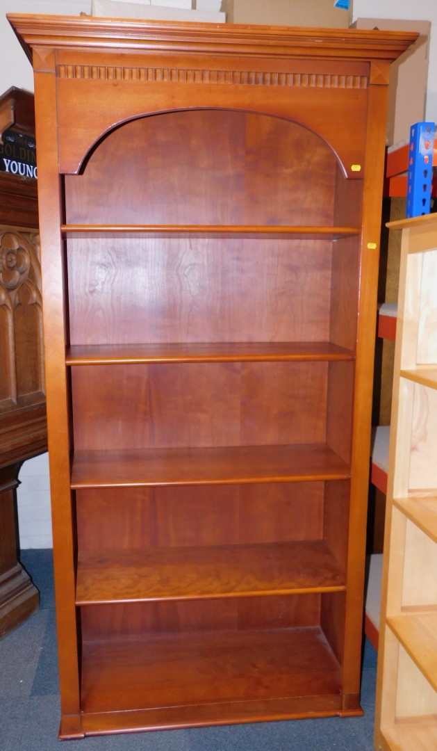 A cherry wood bookcase, enclosing four adjustable shelves, 190cm high, 103cm wide, 41cm deep.