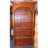 A cherry wood bookcase, enclosing four adjustable shelves, 190cm high, 103cm wide, 41cm deep.