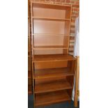 A beech effect bookcase, enclosing four adjustable shelves and one fixed together, 203cm high,