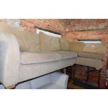 A corner sofa upholstered in beige fabric, 273cm x 162cm.