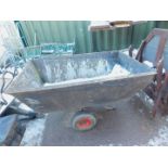 A large galvanised garden wheel barrow.