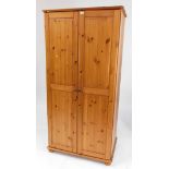 A pine two door wardrobe, 186cm high, 92cm wide, 61cm deep.