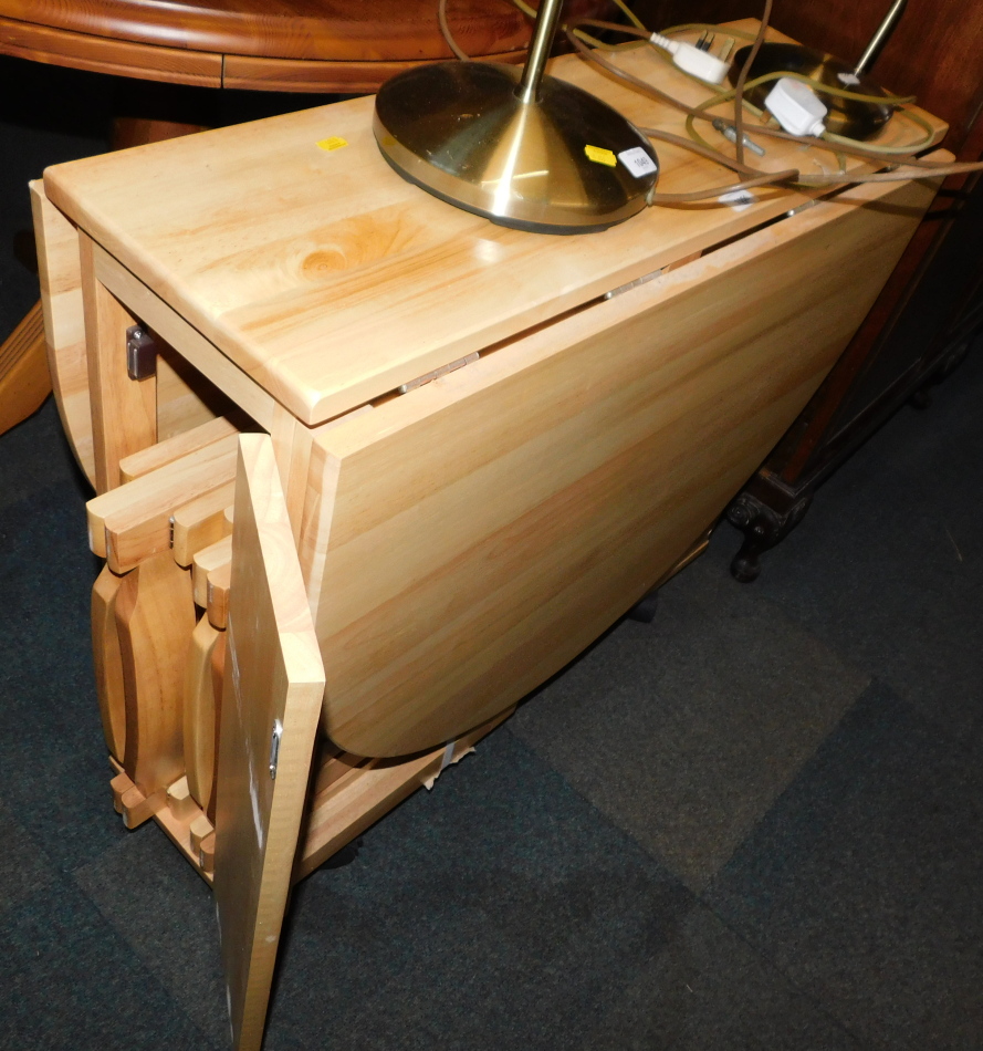 A beech drop leaf kitchen table, 75cm high, 31cm wide, 141cm extended, 86cm deep, enclosing four