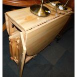 A beech drop leaf kitchen table, 75cm high, 31cm wide, 141cm extended, 86cm deep, enclosing four