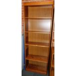 A teak effect bookcase, enclosing four adjustable shelves, 214cm high, 75cm wide, 31cm deep.