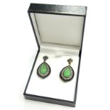A pair of jade, diamond and onyx drop earrings, each set with central cabochon jade, surrounded by
