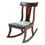 An Edwardian mahogany inlaid rocking chair, the back splat with marquetry inlay with mother of pearl