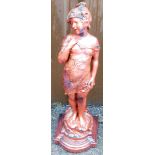 A garden statue of a child, on a rectangular shaped base, painted in red, 65cm high.