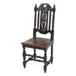 A late 19thC carved oak hall chair, the shield shaped back with barleytwist support columns and leaf