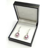 A pair of diamond and ruby drop earrings, each set with central rose cut diamond approx 1.23cts,