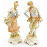A pair of late 19thC Continental porcelain figures, a lady and gentleman, each on a shaped base,