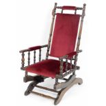 An Edwardian mahogany framed bedroom chair, with red velvet upholstery, on turned supports and