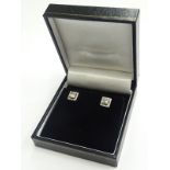 A pair of 18ct white gold princess cut square halo diamond studs, the princess cut stones