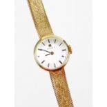 A 9ct gold Tissot ladies cocktail watch, with small silver dial, on a bark effect thin strap, 20cm