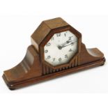 An Art Deco mantel clock, in an oak case with silvered coloured dial,