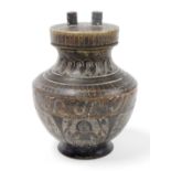 A late 20thC bronze urn shaped vase, with screw on lid with two points, with an overall hammered
