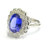 A tanzanite and diamond dress ring, set with oval tanzanite stone, surrounded by round brilliant cut