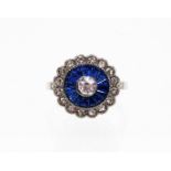An Art Deco style modern target ring, set with blue and white paste stones, on modern costume