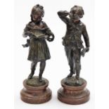 A pair of early 20thC resin figures of children, to include boy and girl on a wooden base, 31cm