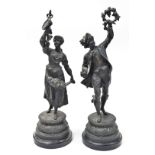 A pair of late 19thC spelter figures, a young lady and gentleman, each with grape vines and flowers,