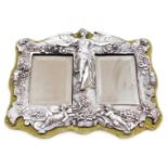 An Art Nouveau style pewter mirror, the outer border with floral and cherub decoration, bears