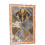 A Middle Eastern embroidered wall hanging, on a dark blue material backing and border, with