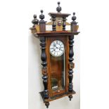 An early 19thC walnut Vienna wall clock, the cornice with pillars and lion mask, with a white enamel