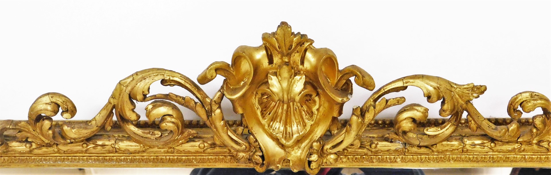 A late 19thC gilt gesso overmantel mirror, with a scroll crest and leaf moulded frame, 153cm high, - Image 2 of 2