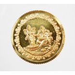 A Tanishq gold coin, depicting two Hindu figures, stamped 995 fine gold, 10g, in presentation sleeve
