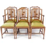 A set of six Edwardian walnut dining chairs, the shaped shield back with central carved floral