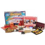 A group of games and trinkets, to include Lightening Action Air Slammers, Jason Donovan Straight