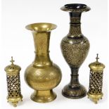 Four Indian brass items, to include a pair of candle stands, with pierced overall detailing, 23cm