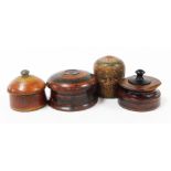 Four wooden Eastern storage jars, each of varying design, two with red and black lacquering, and