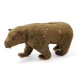 An early 20thC plush stuffed toy bear, 15cm wide, 35cm high.