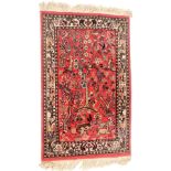 A Persian type rug, with design of birds, on a pink ground with cream border and cream tassel