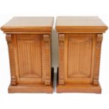 A pair of 19thC oak pedestal cupboards, each moulded top with S scroll and fan pillars, a carved