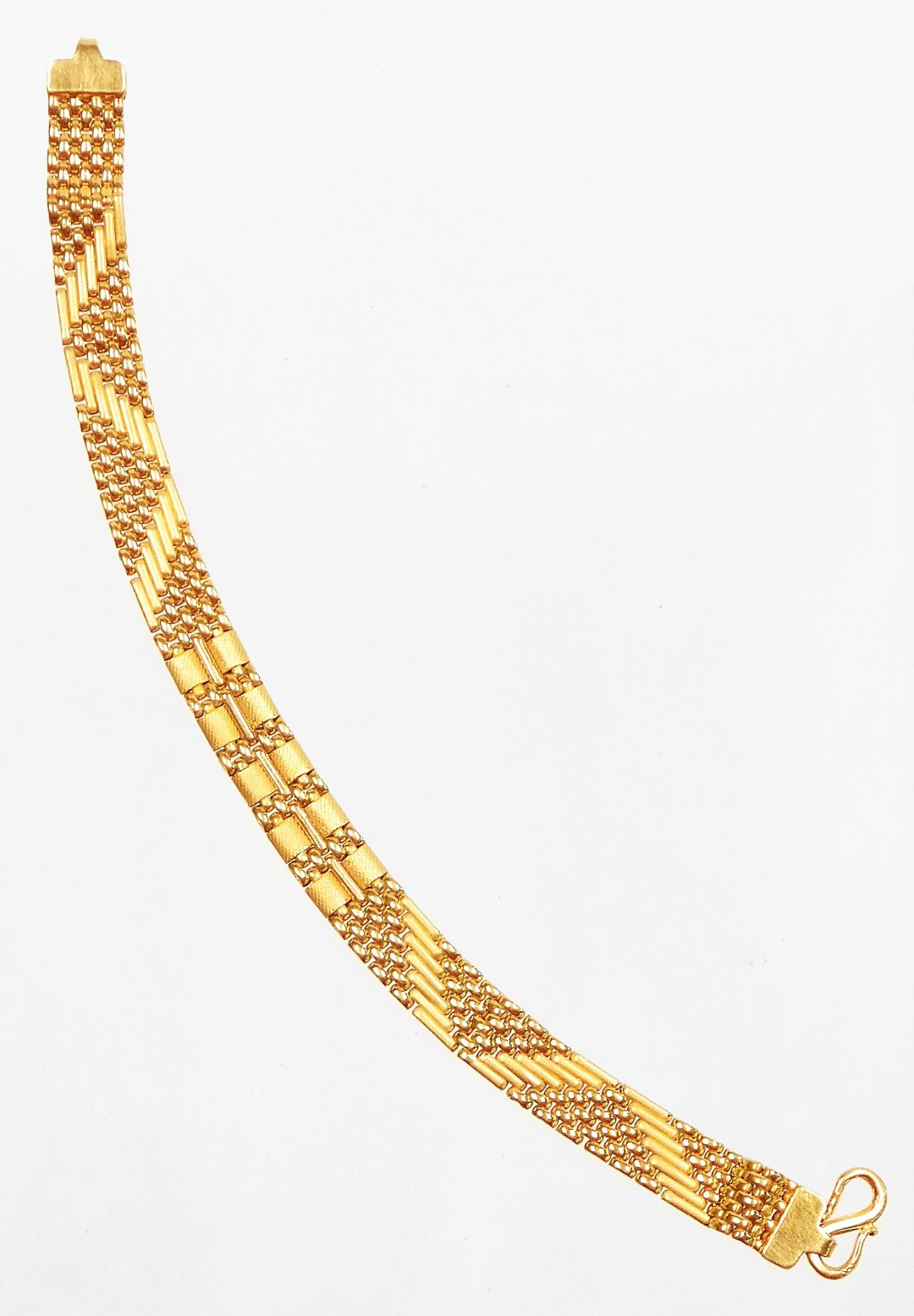 A patterned bracelet, with two outer sections bearing hatching design, with a rubbed five section