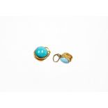 *Two turquoise set pendants, each with stone to each side in a yellow metal frame, unmarked. (2)