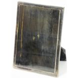 A 20thC photograph frame, of plain rectangular form with ebonised oak easel back, marked P.
