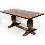 A Jacobean style refectory table, the three plank top on heavy carved circular columns, on a H