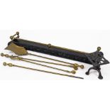 A group of fireside implements, to include a fireside cast metal guard 88cm wide, a cast trivet