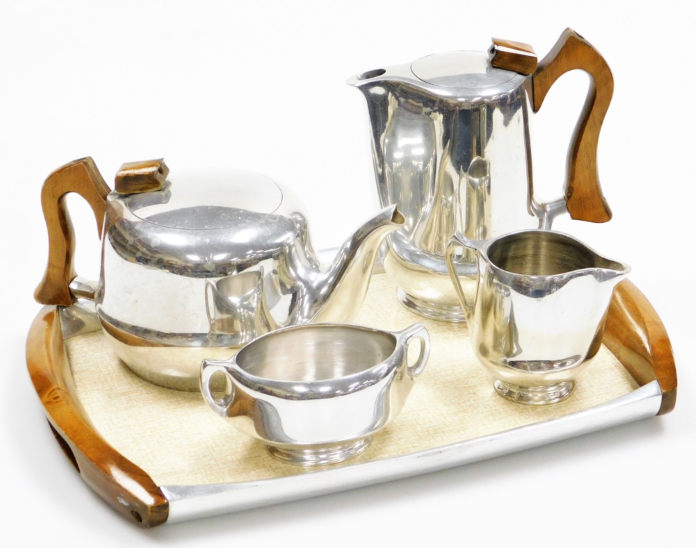 A Piquot ware four piece tea service, comprising coffee pot, milk jug, sugar bowl, teapot and tray.