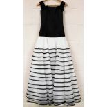 A ladies evening dress, black silk top, and white and black striped ruffled hem skirt, unmarked or