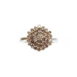 A 9ct white gold diamond dress ring, set in a floral cluster, in a layered decoration, ring size