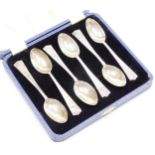 A set of six silver cased teaspoons, each with George V crown emblem to top, and stamped AD 1910.35,